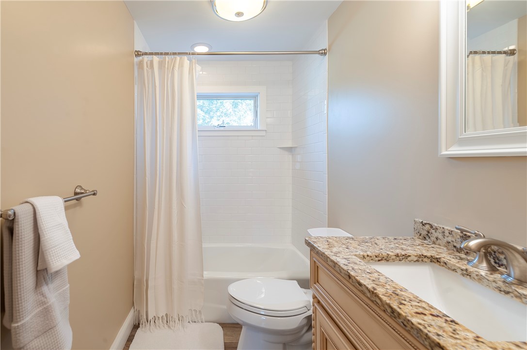 374 Woodhaven Road Pawtucket, RI 02861 - Photo 12 of 25 Beautifully renovated full bath with new flooring, toilet, granite top vanity and classic subway tile surrounds tub/shower combination. Located just outside master bed