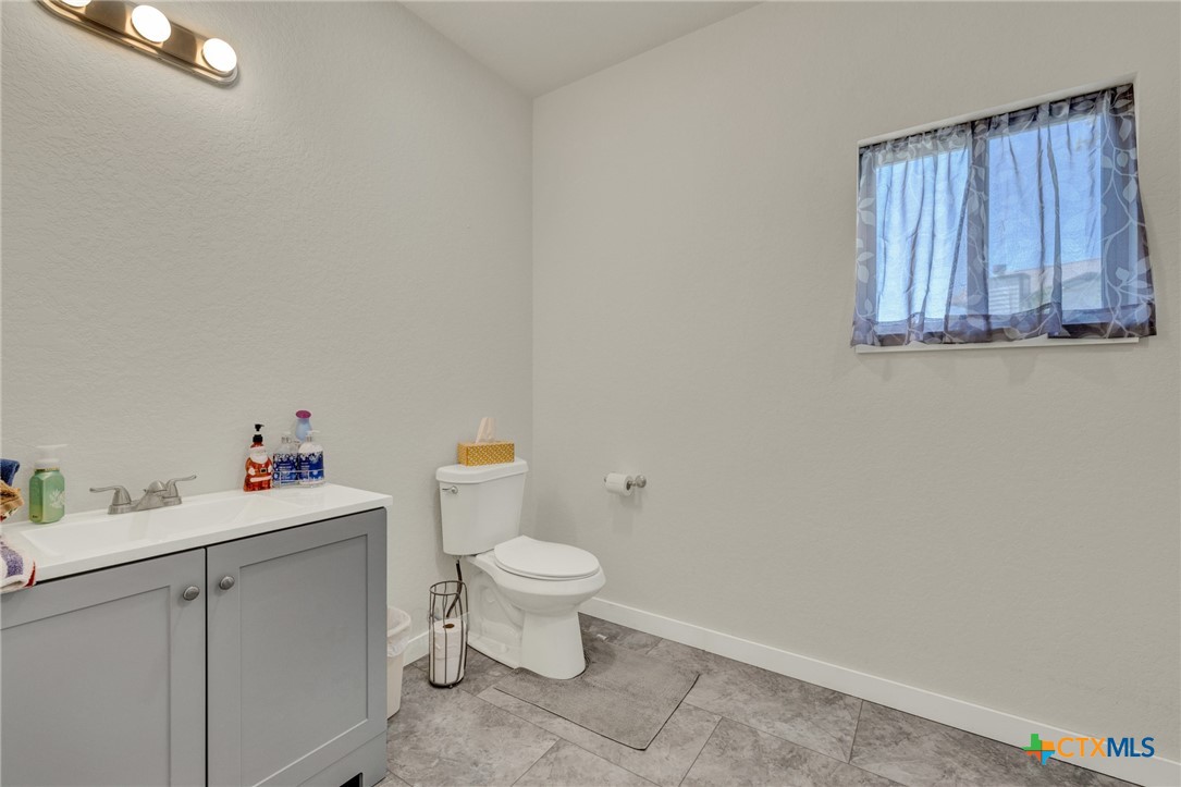 305 Lake Crest Spring Branch, TX 78070 - Photo 15 of 38 a bathroom with a sink toilet and vanity