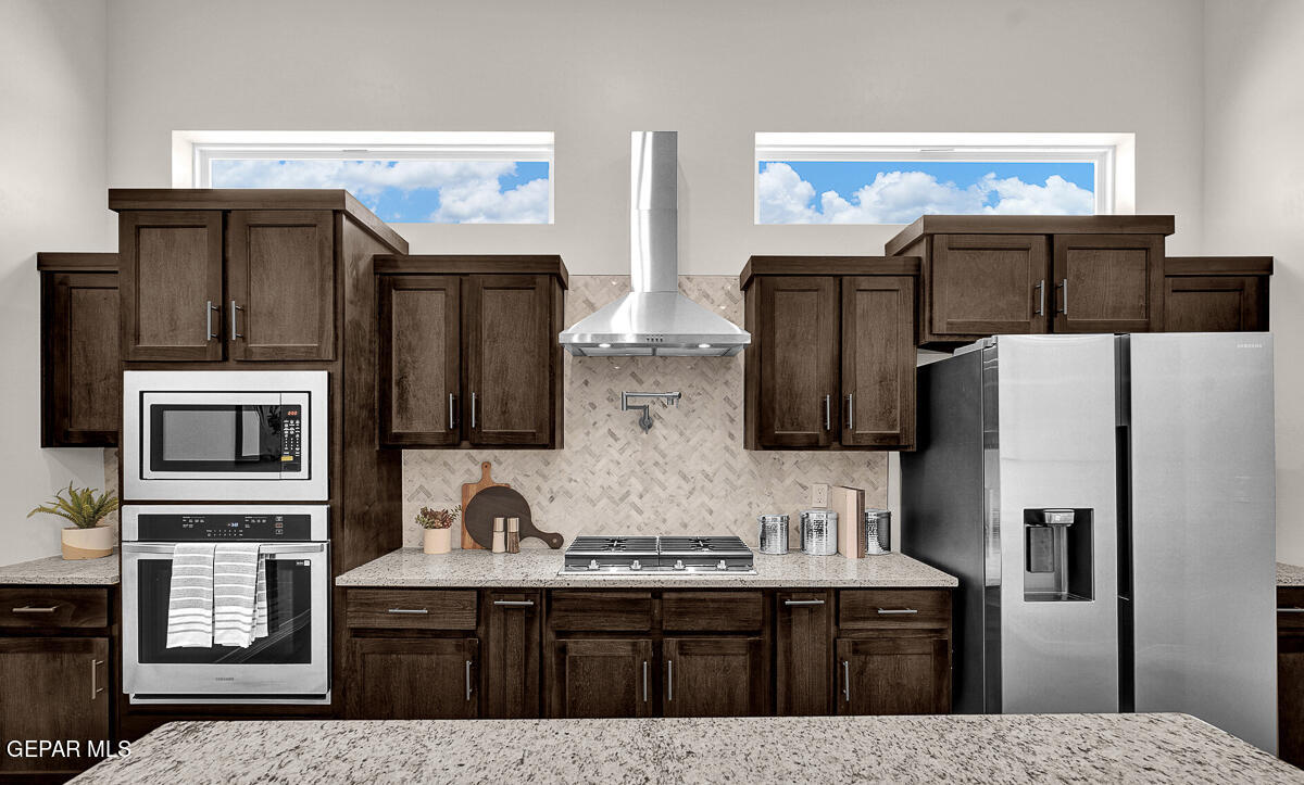 7625 Enchanted Ridge Drive El Paso, TX 79911 - Photo 21 of 57 a kitchen with stainless steel appliances a sink cabinets and refrigerator