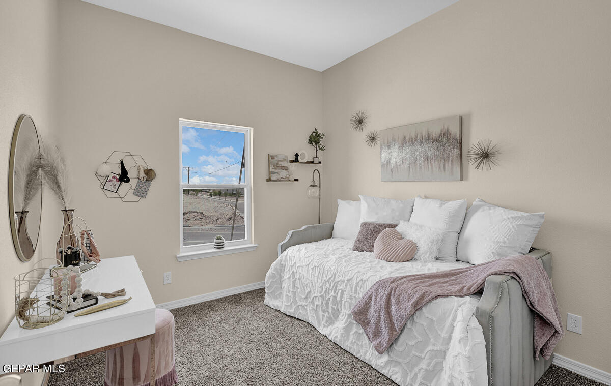 7625 Enchanted Ridge Drive El Paso, TX 79911 - Photo 30 of 57 a bedroom with a bed and wooden floor