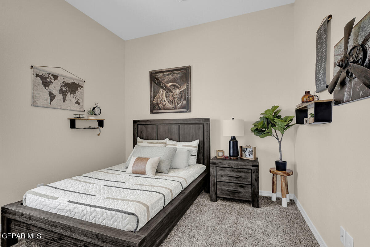 7625 Enchanted Ridge Drive El Paso, TX 79911 - Photo 33 of 57 a bedroom with a bed and a potted plant
