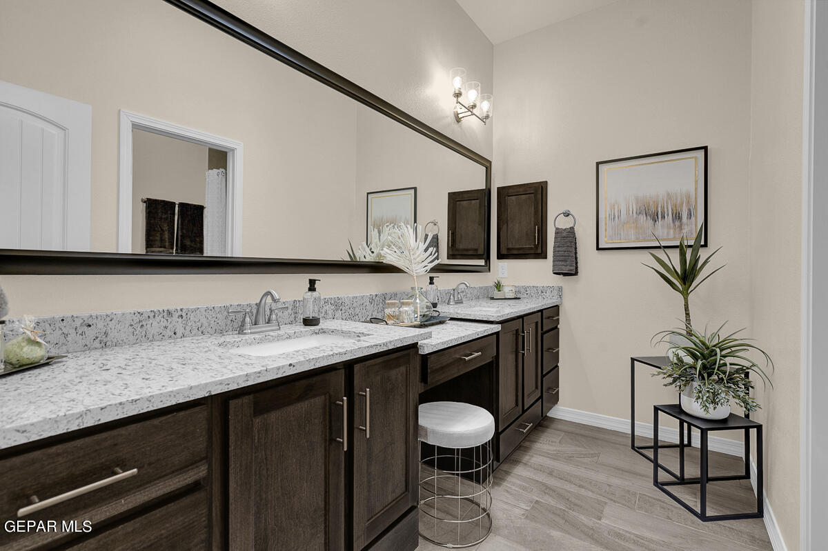 7625 Enchanted Ridge Drive El Paso, TX 79911 - Photo 35 of 57 a spacious bathroom with a granite countertop sink a mirror and a