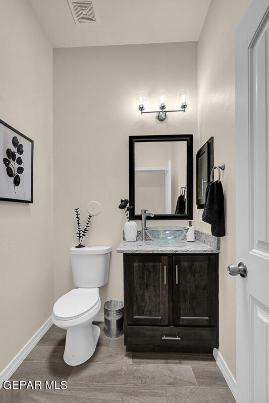 7625 Enchanted Ridge Drive El Paso, TX 79911 - Photo 39 of 57 a bathroom with a toilet sink and mirror
