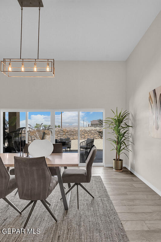 7625 Enchanted Ridge Drive El Paso, TX 79911 - Photo 7 of 57 a dining room with furniture and wooden floor