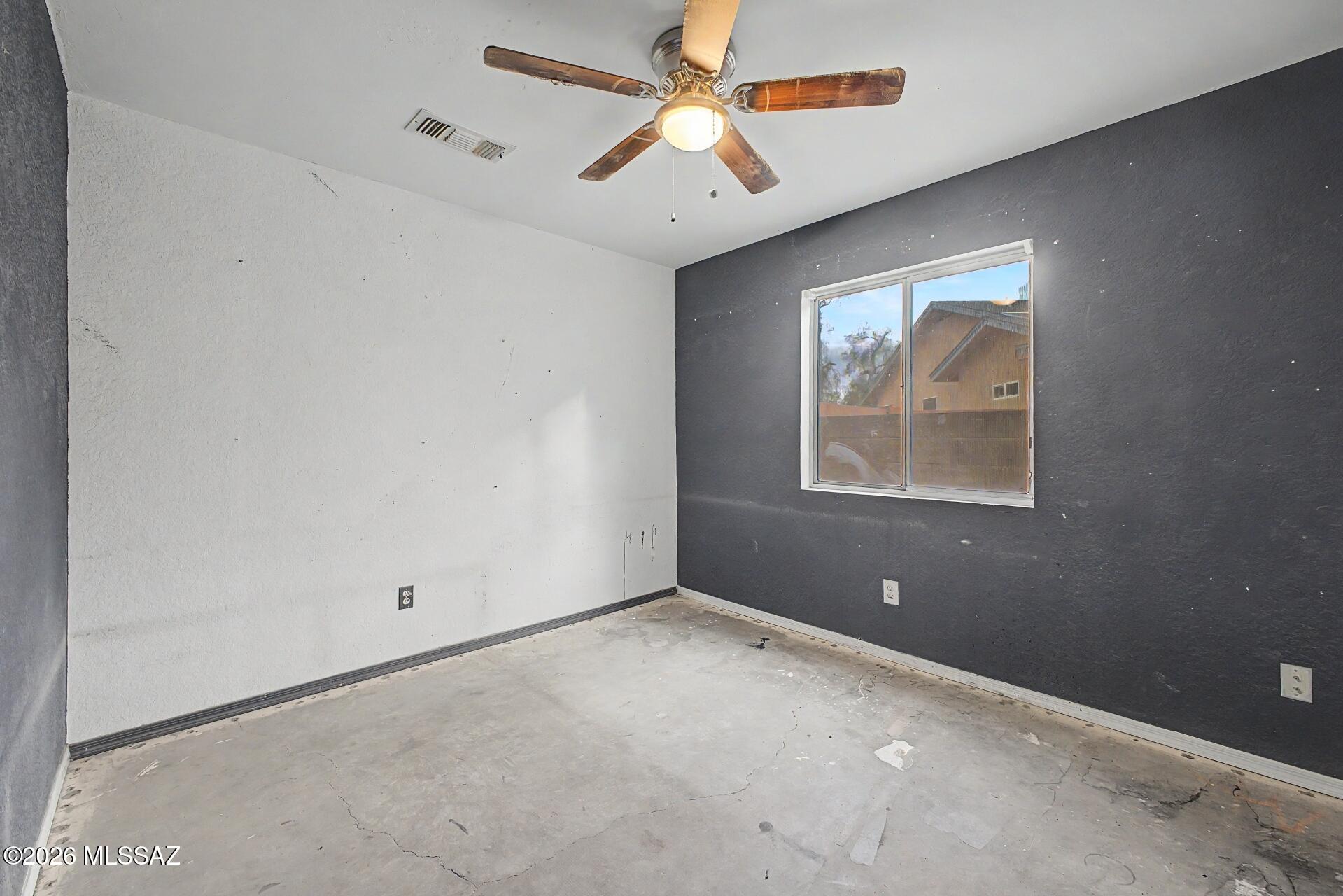 9810 East Stonehaven Way Tucson, AZ 85747 - Photo 23 of 27 an empty room with windows and fan