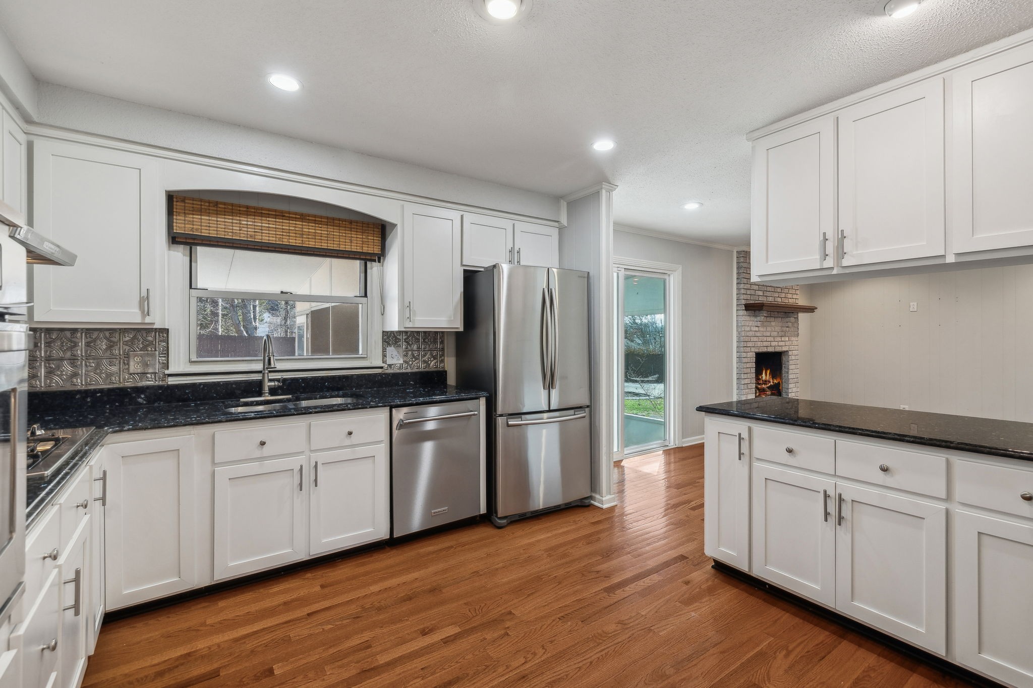 4 Trahern Terrace Clarksville, TN 37040 - Photo 12 of 66 a kitchen with granite countertop white cabinets white stainless steel appliances and wooden floors