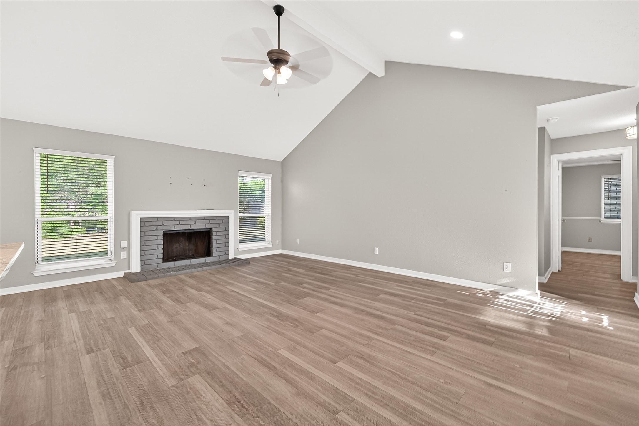 9507 Secretariat Drive Houston, TX 77065 - Photo 11 of 41 a view of empty room with wooden floor and fireplace