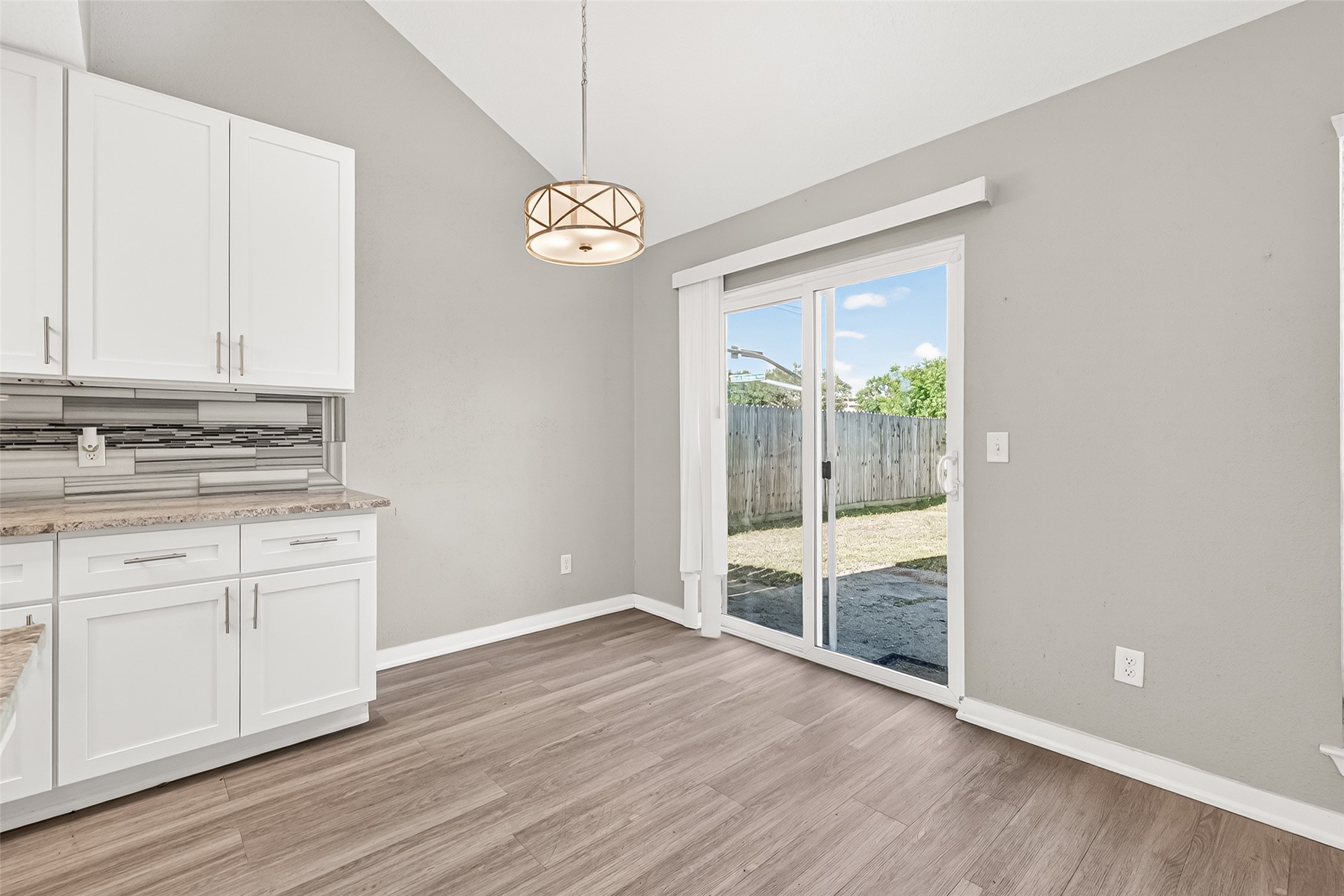 9507 Secretariat Drive Houston, TX 77065 - Photo 12 of 41 an empty room with wooden floor and windows