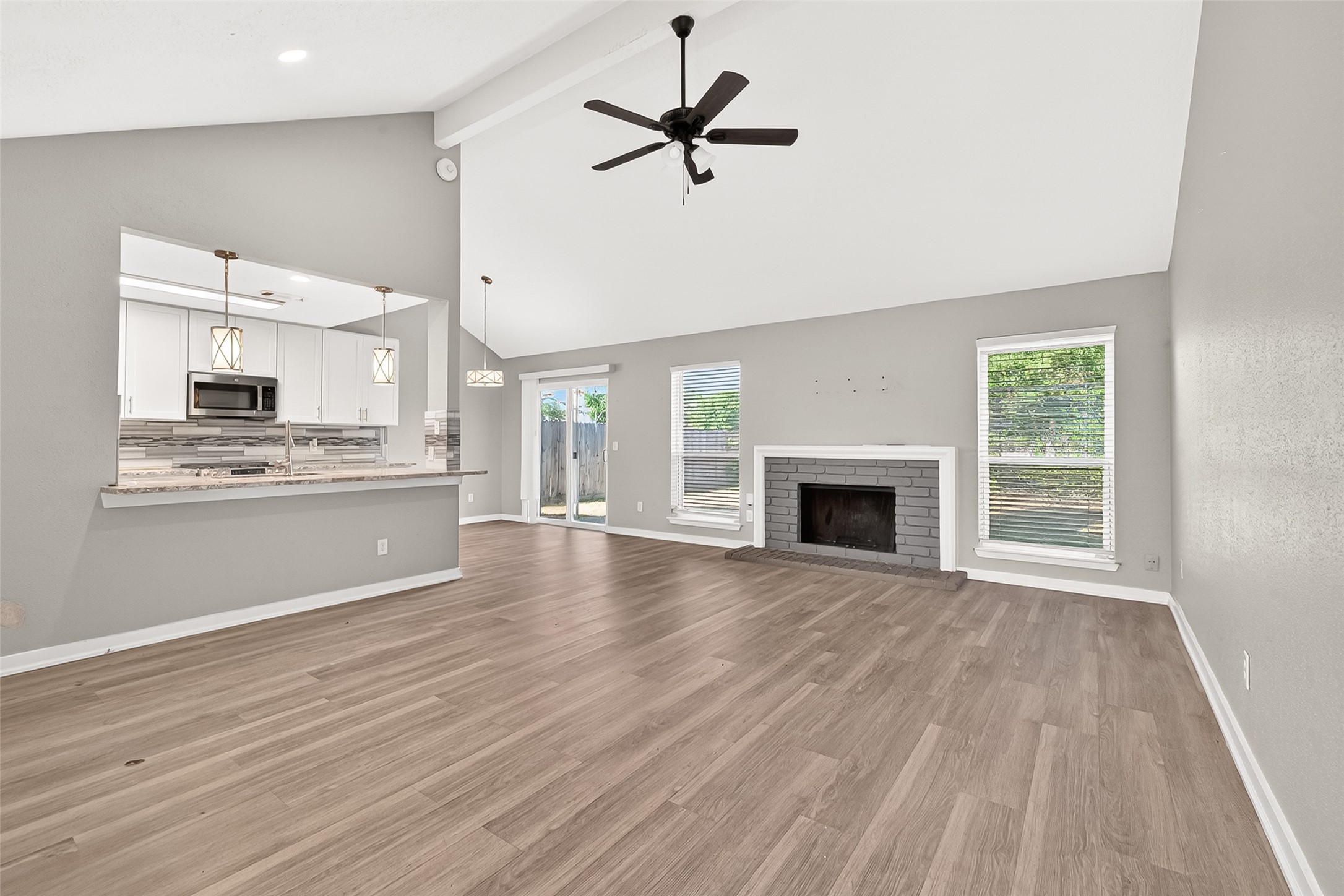 9507 Secretariat Drive Houston, TX 77065 - Photo 13 of 41 a view of an empty room with a kitchen and a window