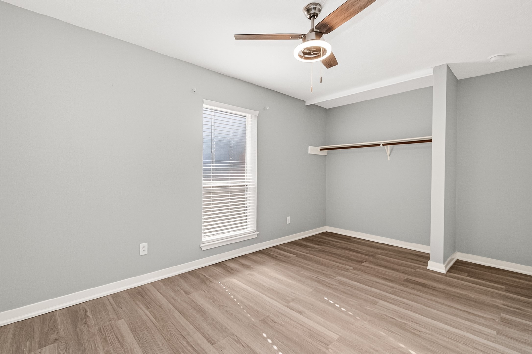 9507 Secretariat Drive Houston, TX 77065 - Photo 36 of 41 an empty room with wooden floor ceiling fan and windows