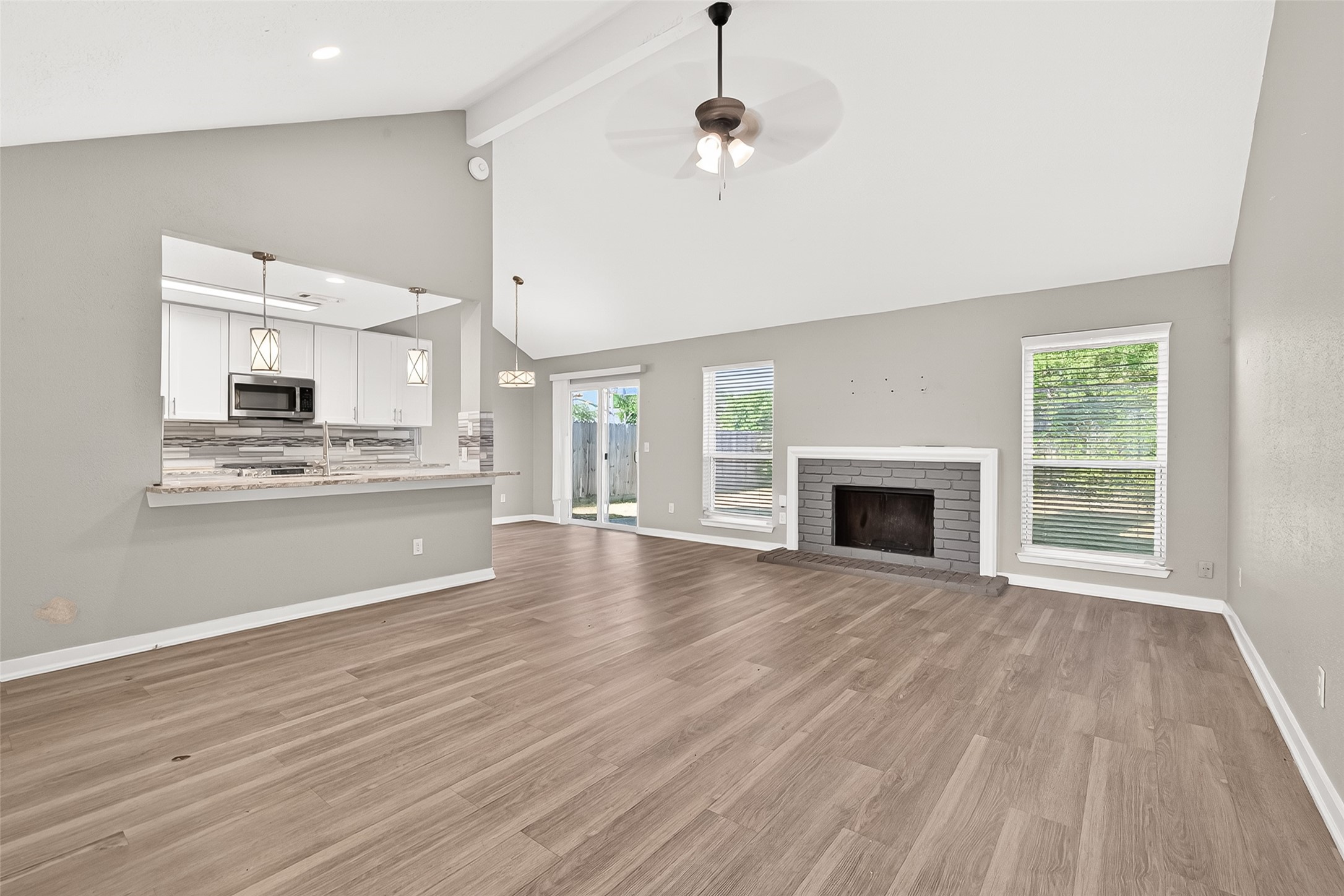 9507 Secretariat Drive Houston, TX 77065 - Photo 8 of 41 a view of an empty room with kitchen and a window