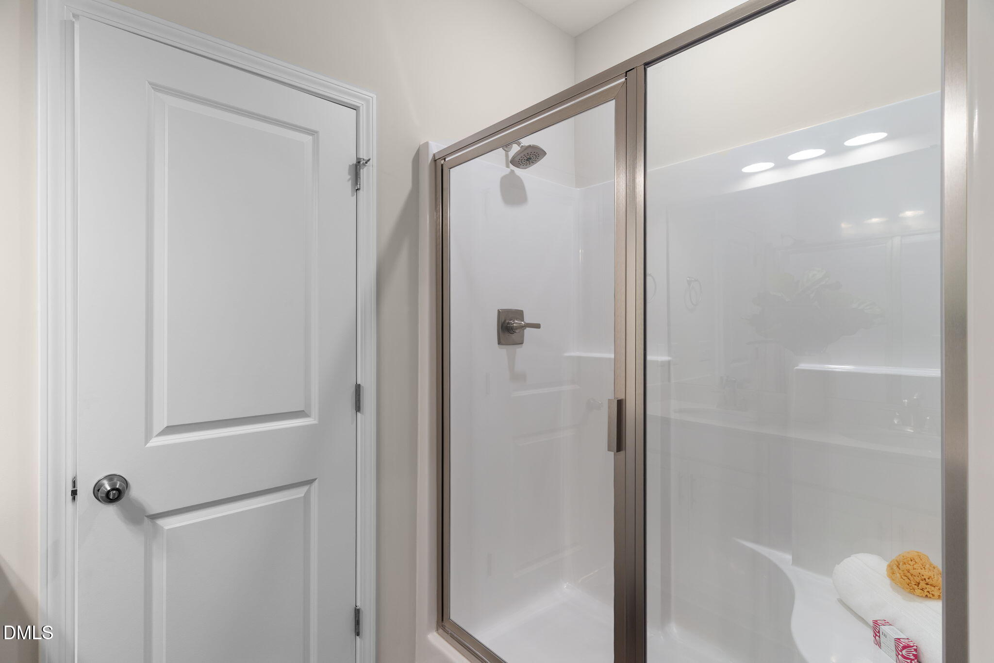 212 Kerag Way Garner, NC 27529 - Photo 24 of 28 a bathroom with a glass shower door and a shower