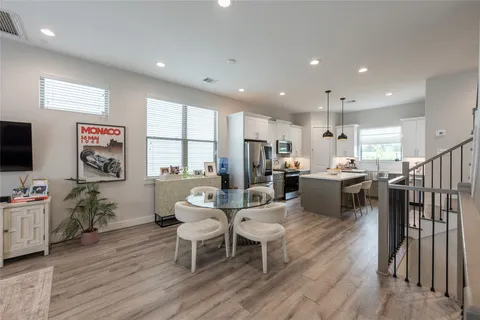 a living room with dining room and wooden floor