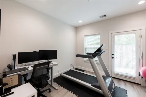 a living room with furniture kitchen view and a chandelier