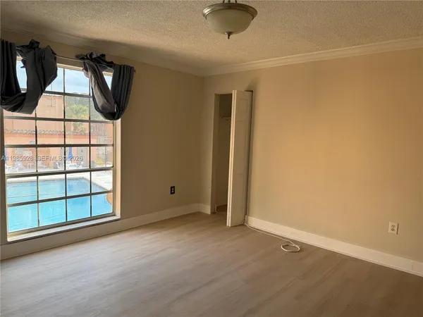 an empty room with windows and closet