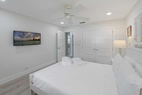 839 Enfield Street Boca Raton, FL 33487 - Photo 16 of 36 a spacious bedroom with a bed and a chandelier