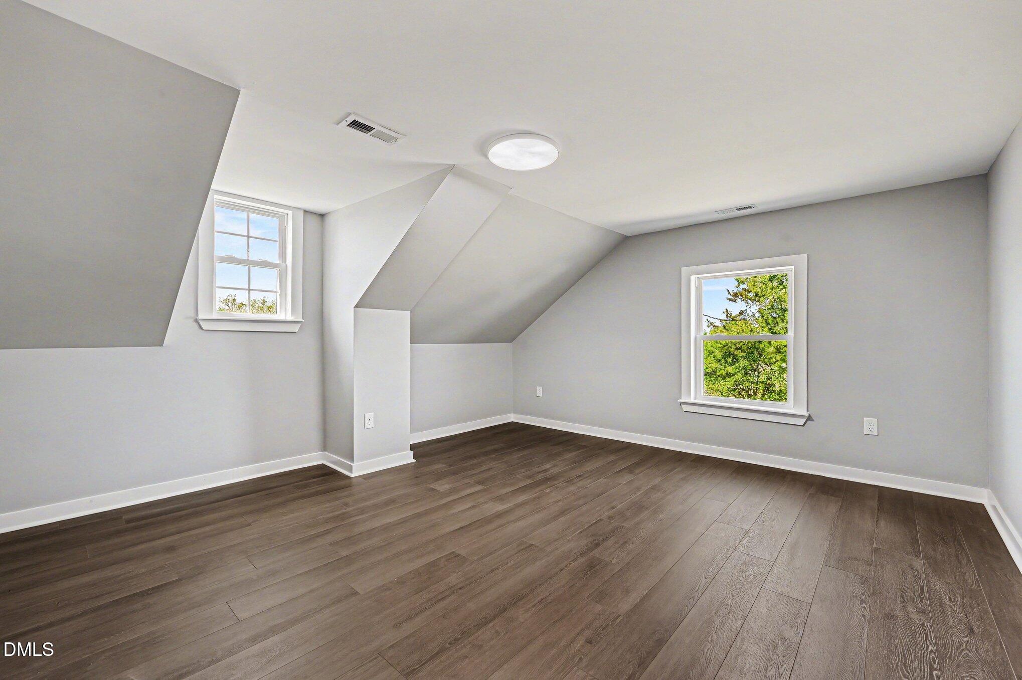 1325 Charlie Carr Road Roxboro, NC 27574 - Photo 28 of 31 an empty room with wooden floor and windows