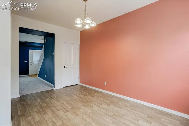 a view of a chandelier fan and entryway