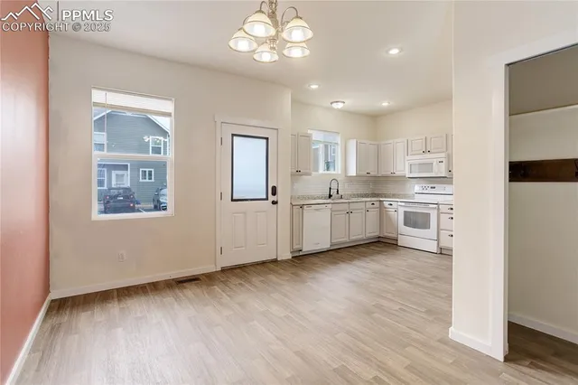 a view of a kitchen with microwave and cabinets