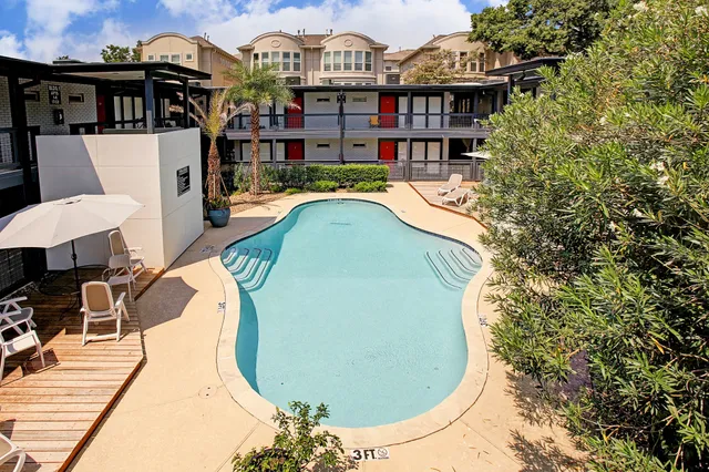 a front view of a house with swimming pool and porch