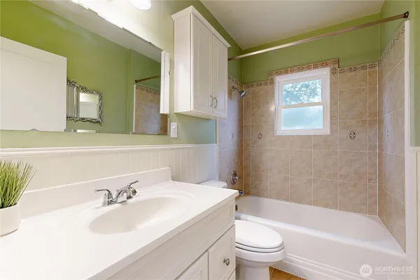 a kitchen with a refrigerator and white cabinets
