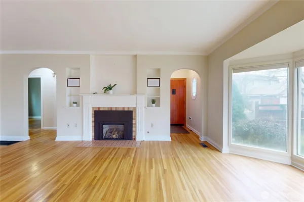 a view of living room with a fireplace and wooden floor