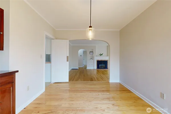 a view of empty room with wooden floor
