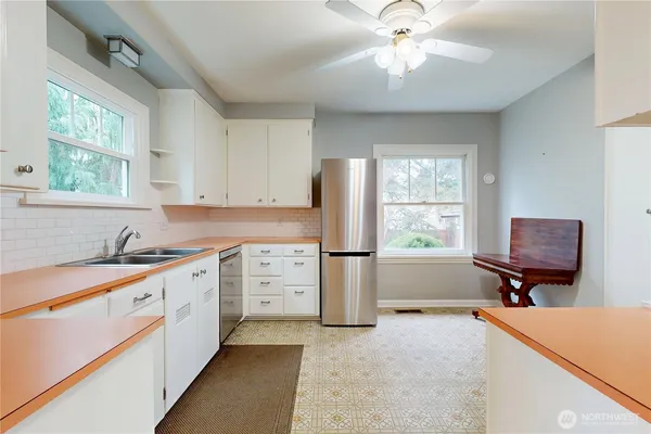 a kitchen with a refrigerator a sink and a stove