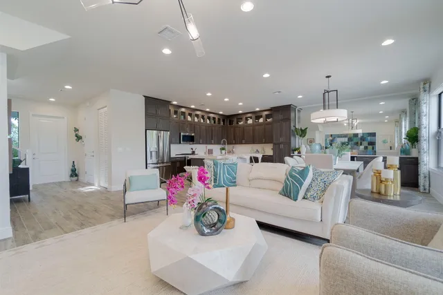 a kitchen with kitchen island granite countertop a sink a counter space and cabinets
