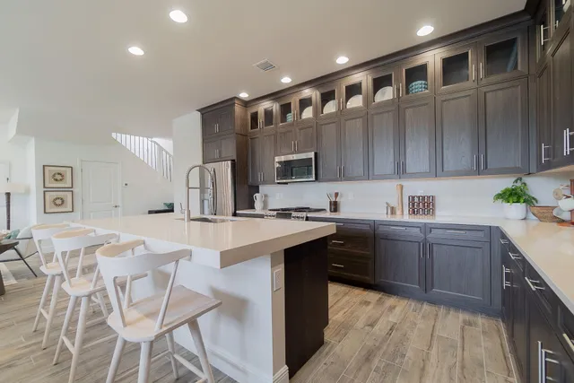 a large kitchen with a table and chairs