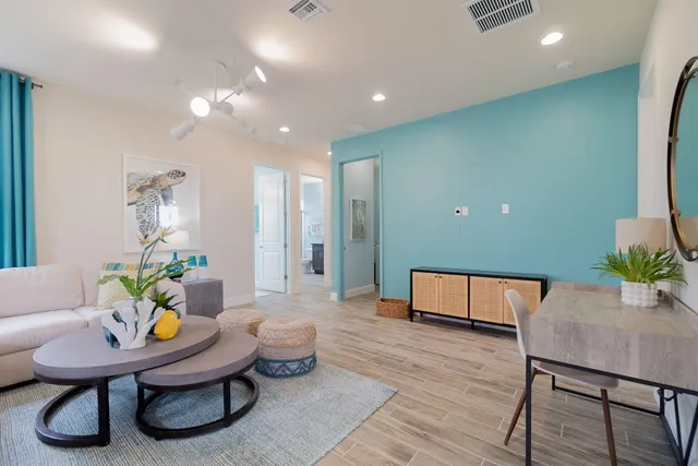 a spacious bedroom with a large bed and a chandelier