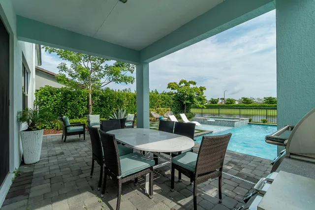 an aerial view of residential houses with outdoor space and lake view
