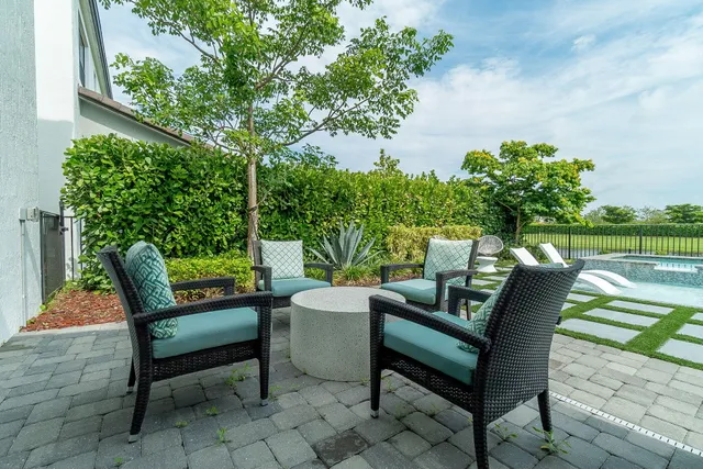 an aerial view of residential houses with outdoor space and swimming pool