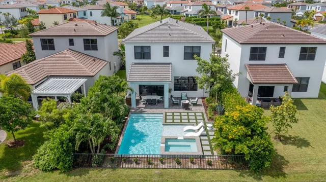 a sign board with a big yard and palm trees