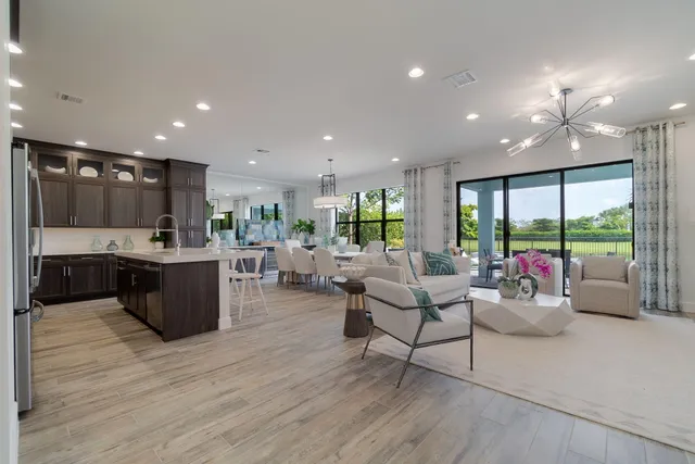 a kitchen with granite countertop a refrigerator and a stove top oven