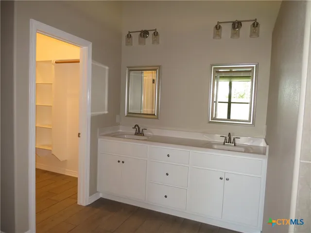 a bathroom with 2 sink and a window