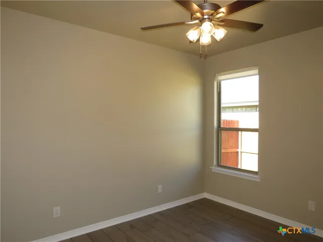 a view of a hallway with a chandelier fan