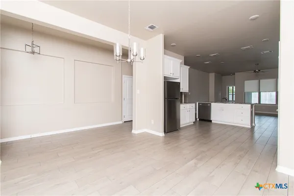 a view of a kitchen with a refrigerator and a sink