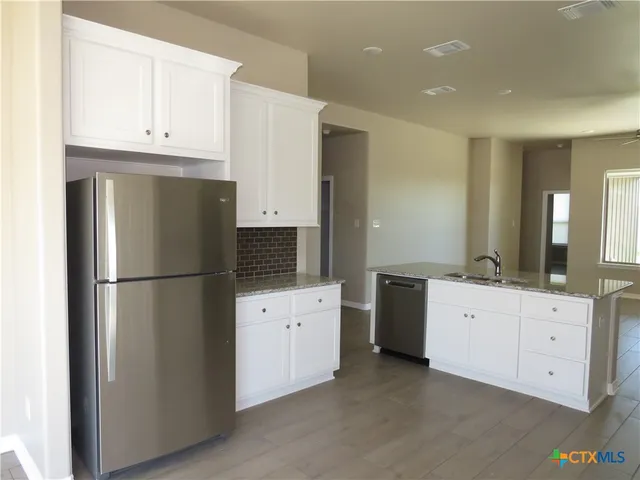 a kitchen with cabinets appliances
