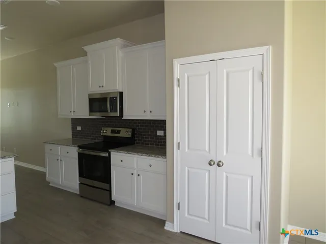 a kitchen with white cabinets