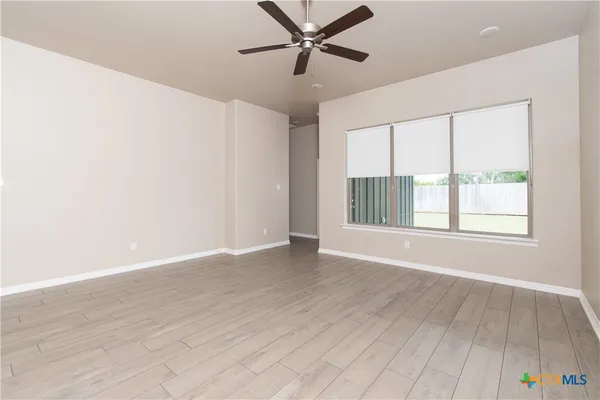 wooden floor in an empty room with a window