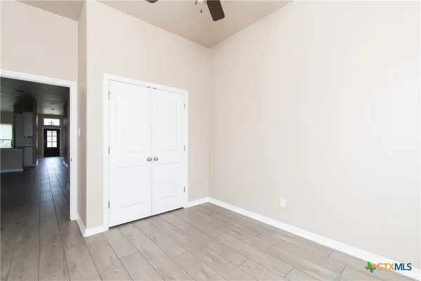 a view of a hallway with wooden floor