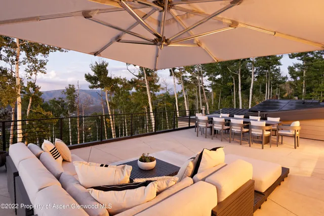 a view of a patio with a table chairs and a umbrella