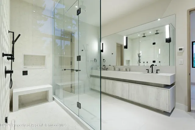 a spacious bathroom with a shower sink and mirror