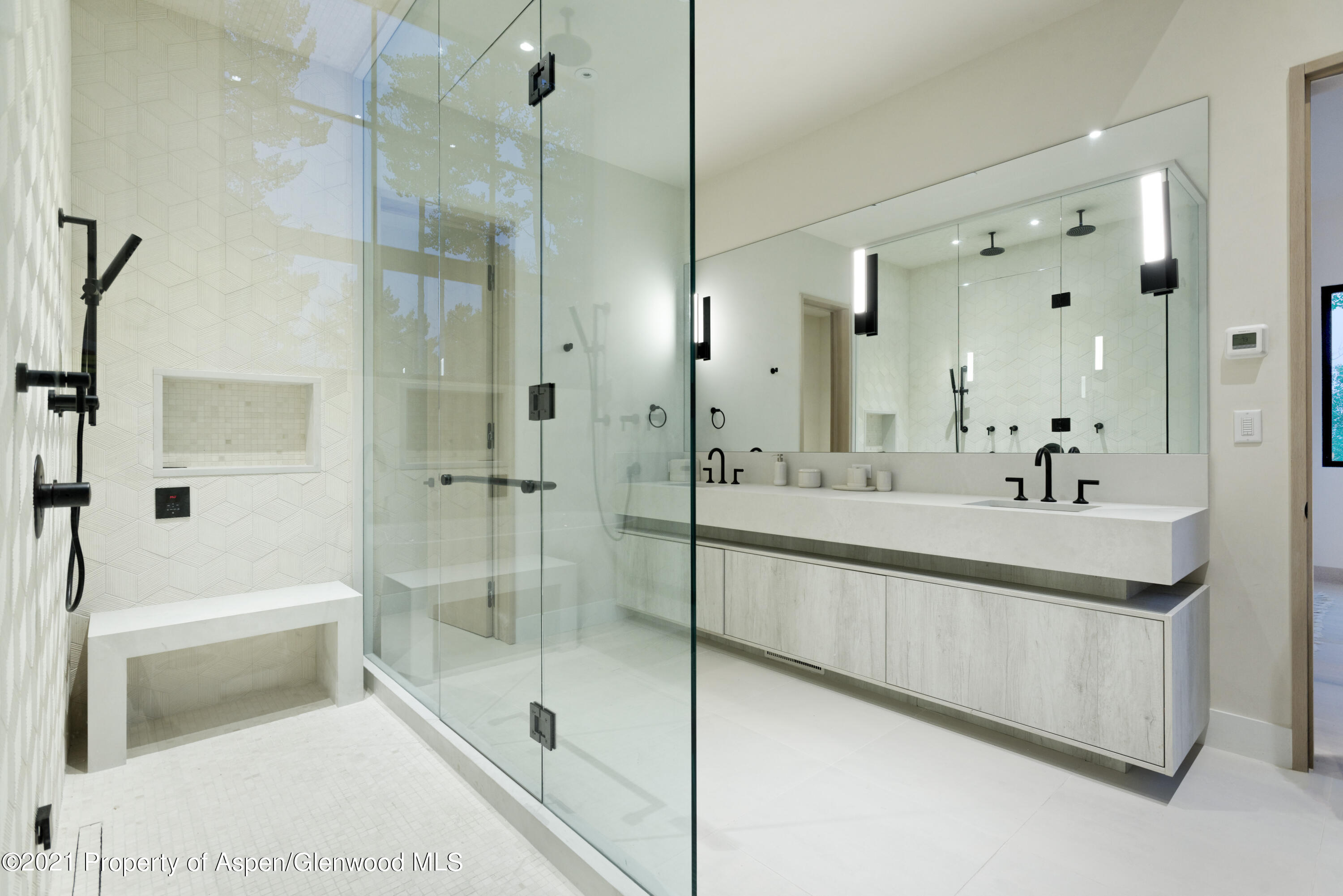 144 Bridge Lane Snowmass Village, CO 81615 - Photo 9 of 28 a spacious bathroom with a shower sink and mirror