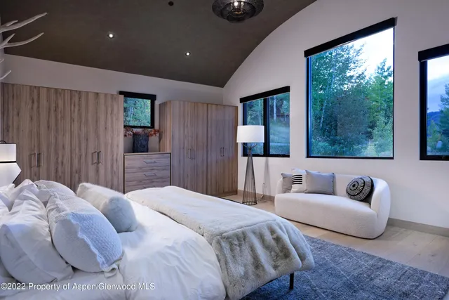 a spacious bedroom with a bed and a couch