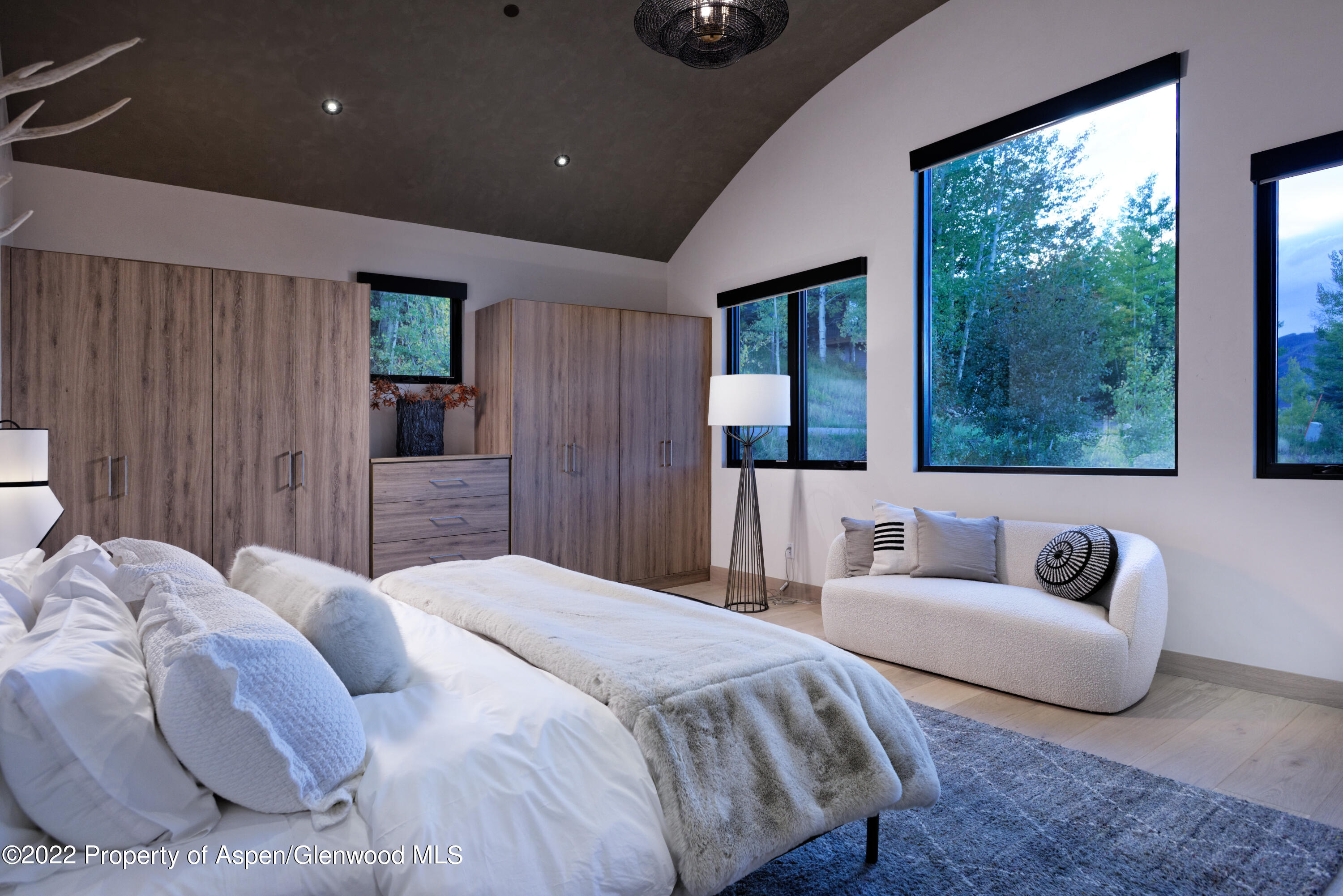 144 Bridge Lane Snowmass Village, CO 81615 - Photo 10 of 28 a spacious bedroom with a bed and a couch