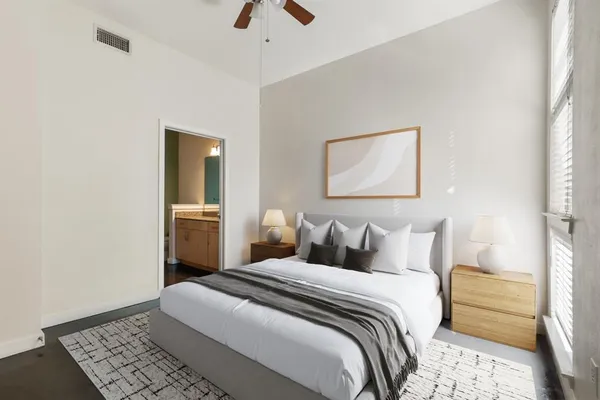 a bedroom with a bed and a painting on the wall