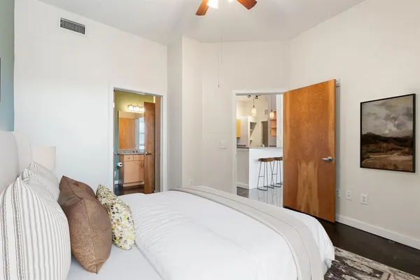 a bedroom with a bed and a painting on the wall