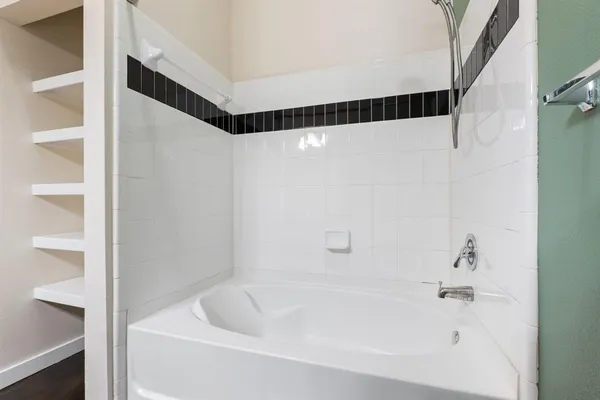 a bathroom with a bathtub and a shower
